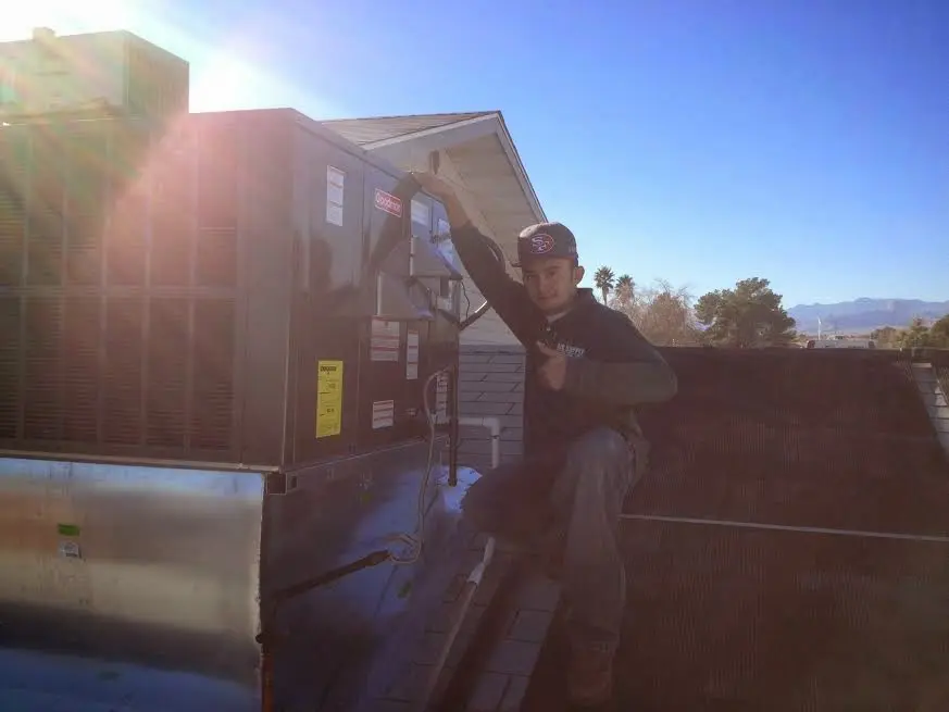 HVAC technician performing Heat Pump Repair on a rooftop unit in Seffner